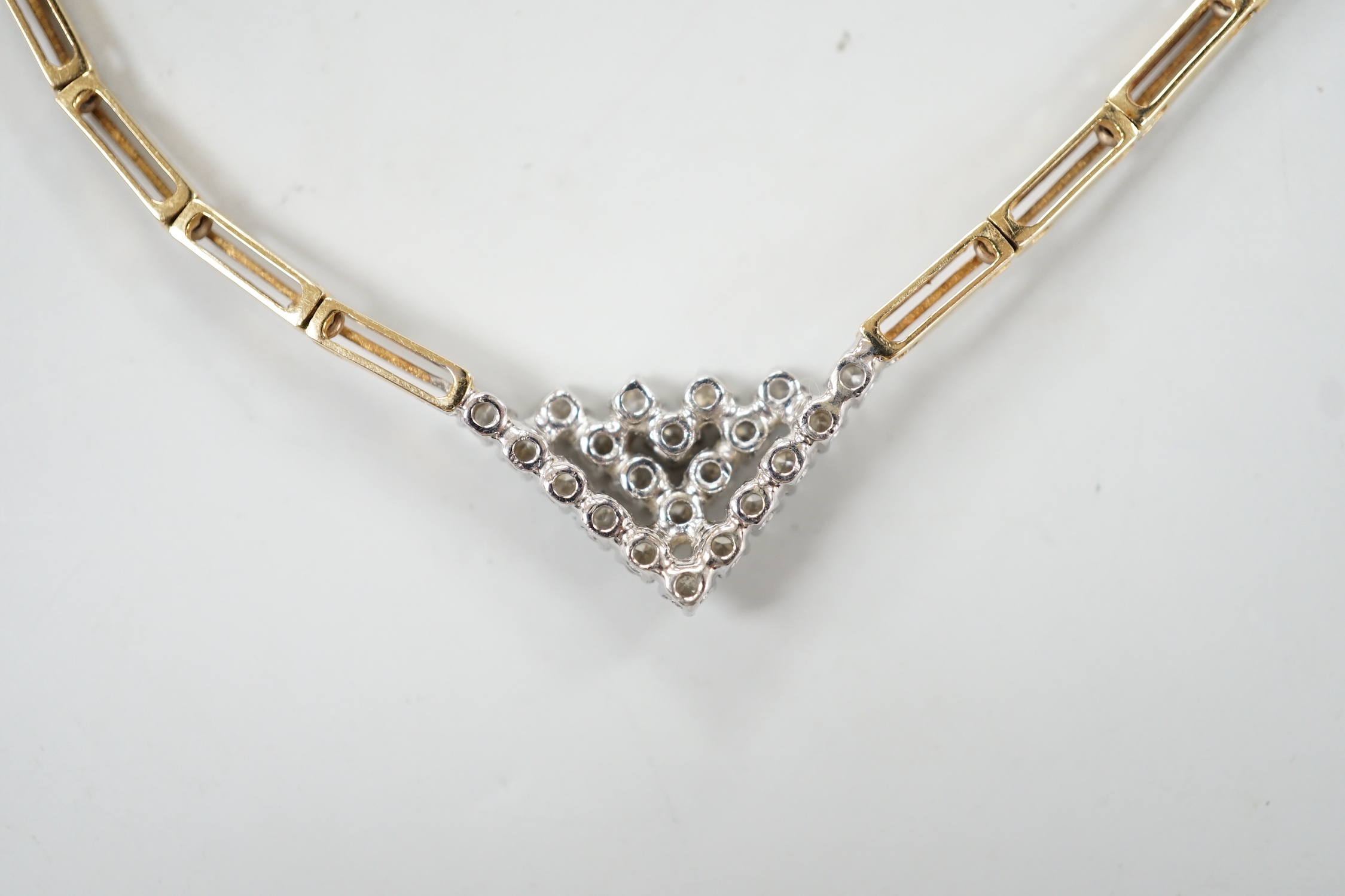 A modern 14kt yellow metal gold diamond cluster set V shaped necklace, approx. 40cm, gross weight 19 grams.